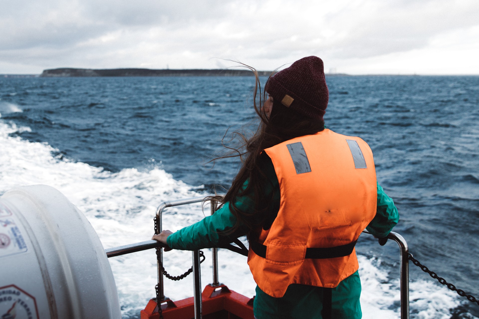 Woman sailing to an island at Pacific Ocean in Chilean Patagonia